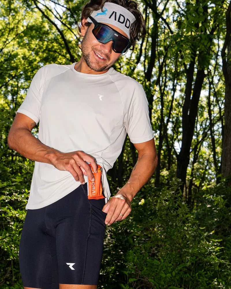 Professional triathlete Alec Shields tucking an ADDRA bar into his pocket before heading out