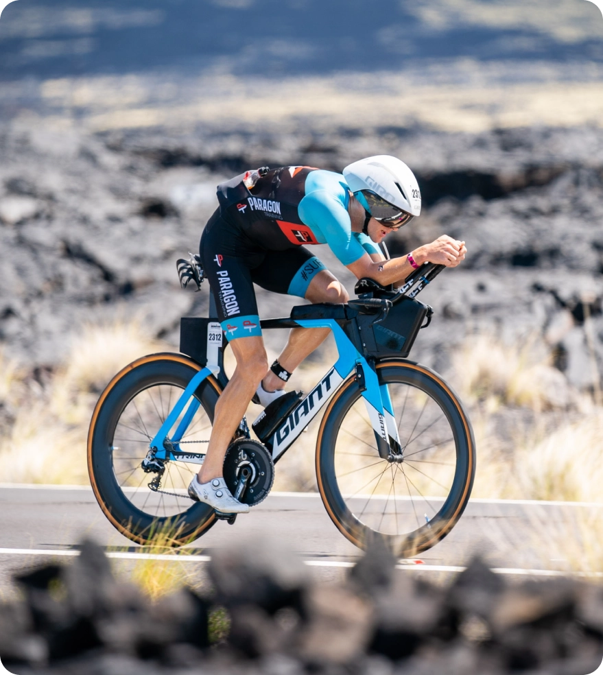 close up of triathlete cycling on open road